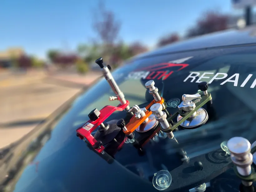In the process of repairing a windshield chip on a Stealth company car