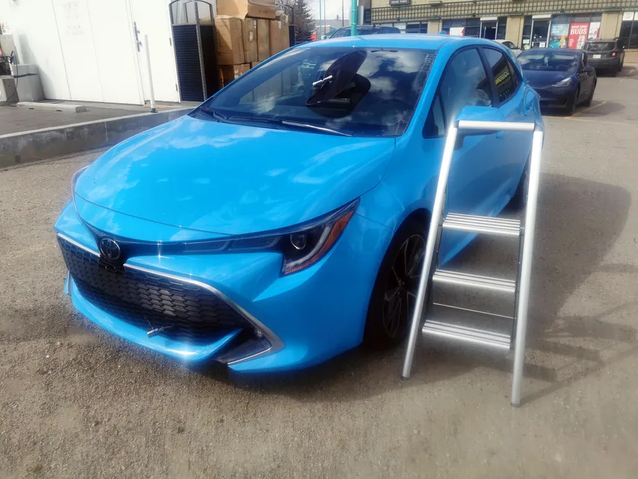 A dazzling 2019 Toyota Corolla Hatchback after paint protection film and windshield chip repair at a Stealth WIndshield Repairs tent