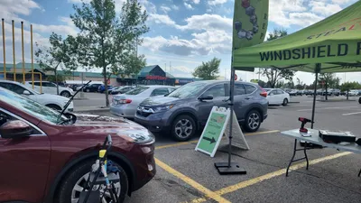 Four cars undergoing repairs at one of our Stealth Windshield Repair tents