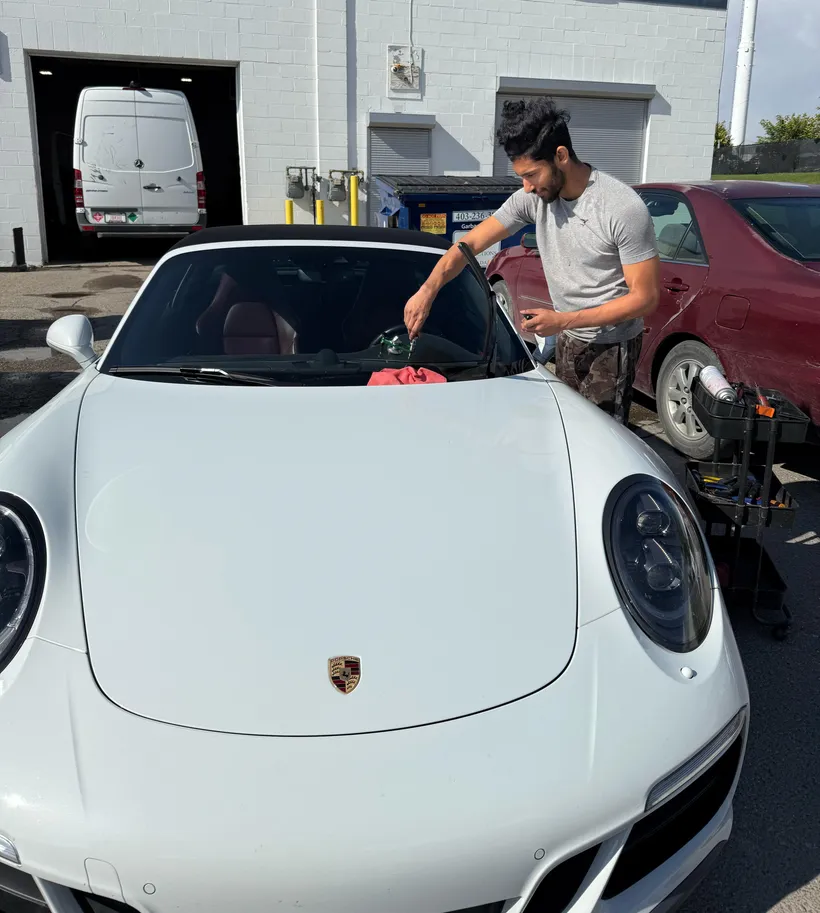 Fixing a frontside windshield chip of a stunning white Porsche Cayman