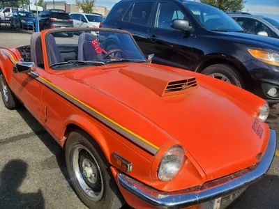 A Triumph Spitfire 1500, a classic British sports car, after undoing paint protection film and windshield chip repair at Stealth tent