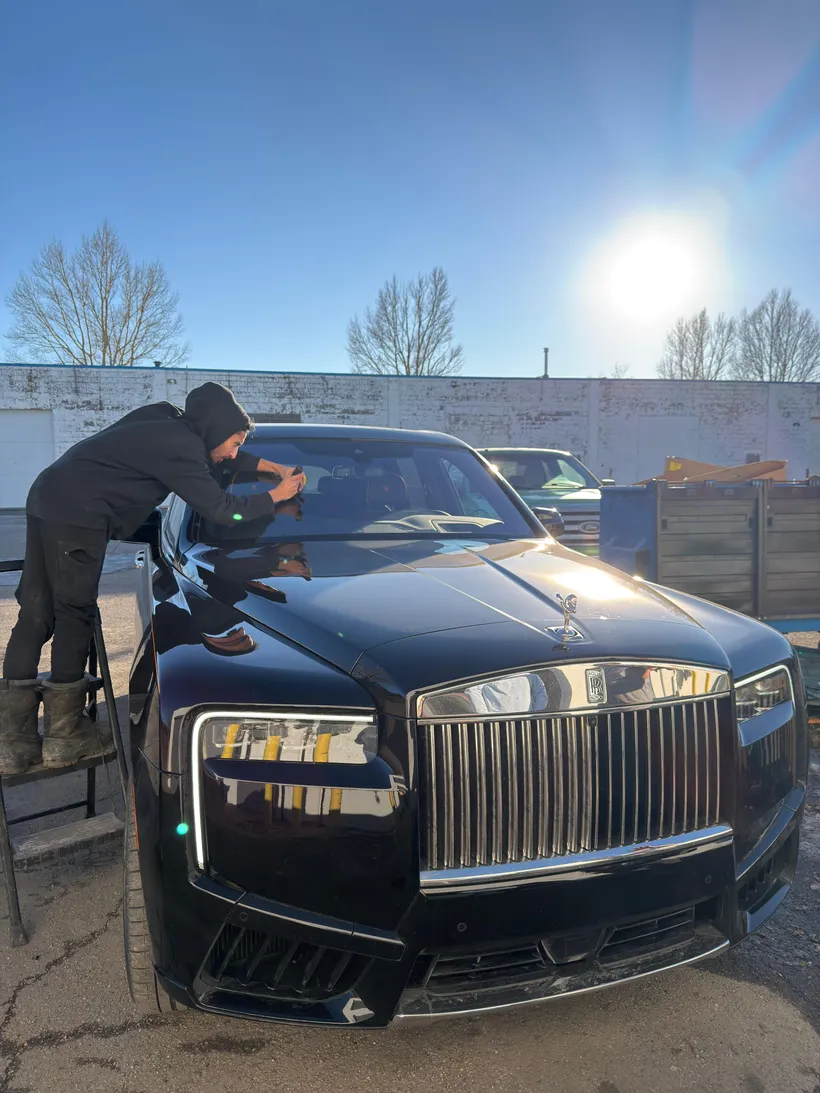 Fixing a windshield chip on a Rolls-Royce Cullinan at a Stealth Windshield Repair tent