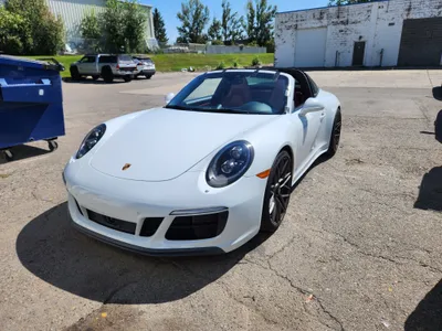 A white Porsche Cayman after windshield replacement at Stealth windshield repair